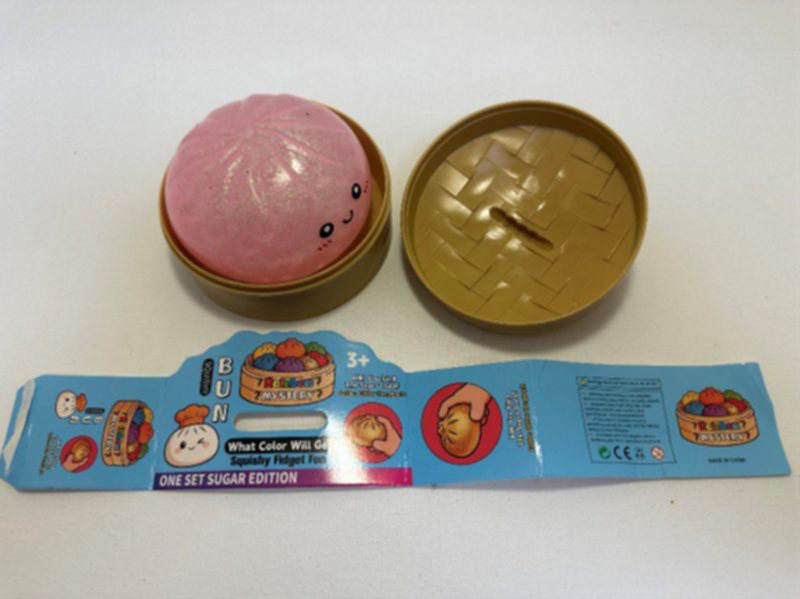 Recalled Rainbow Mystery Squishy Bun, tan container and packaging