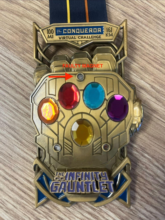 Recalled Avengers Infinity Gauntlet Medal showing faulty magnet